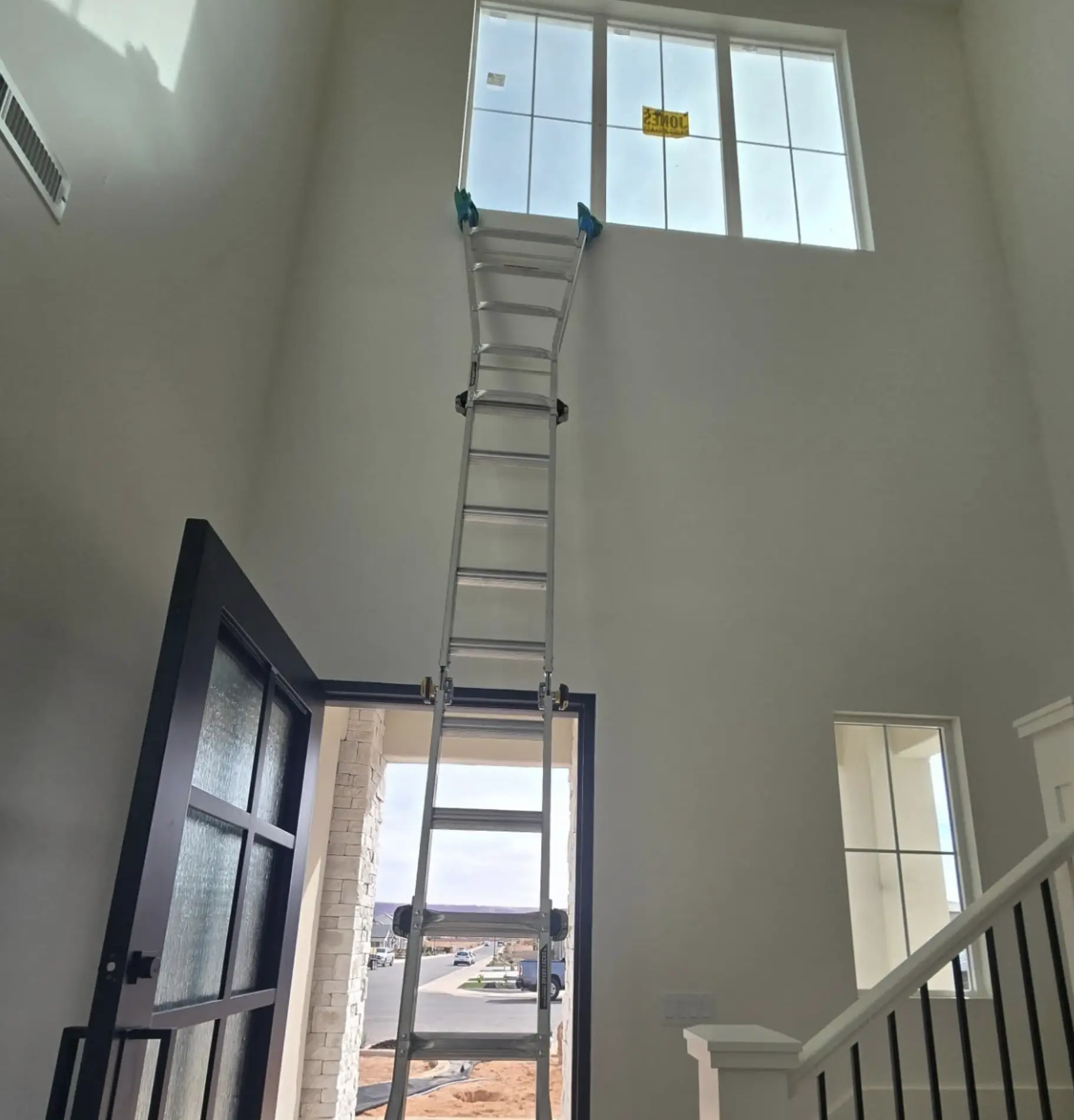 How do you clean high interior windows without a ladder?